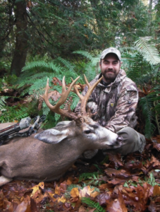 Mathews Cook poses with a black-tailed buck he harvested.